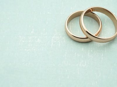 two gold wedding rings overlapping