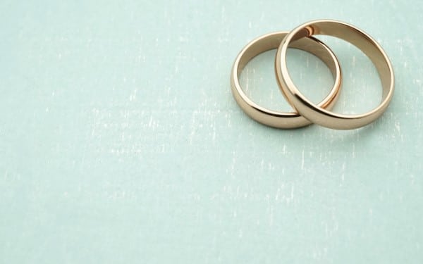 two gold wedding rings overlapping