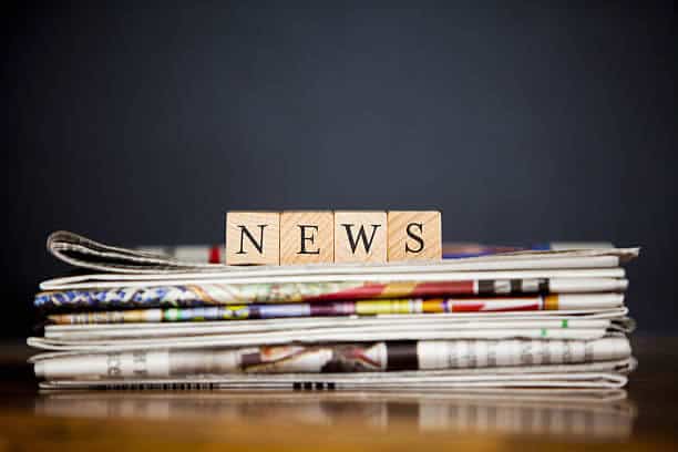 wooden letters on newspaper